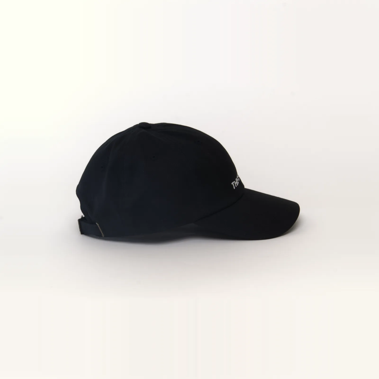 Black hat that says THIS IS A HAT, side view