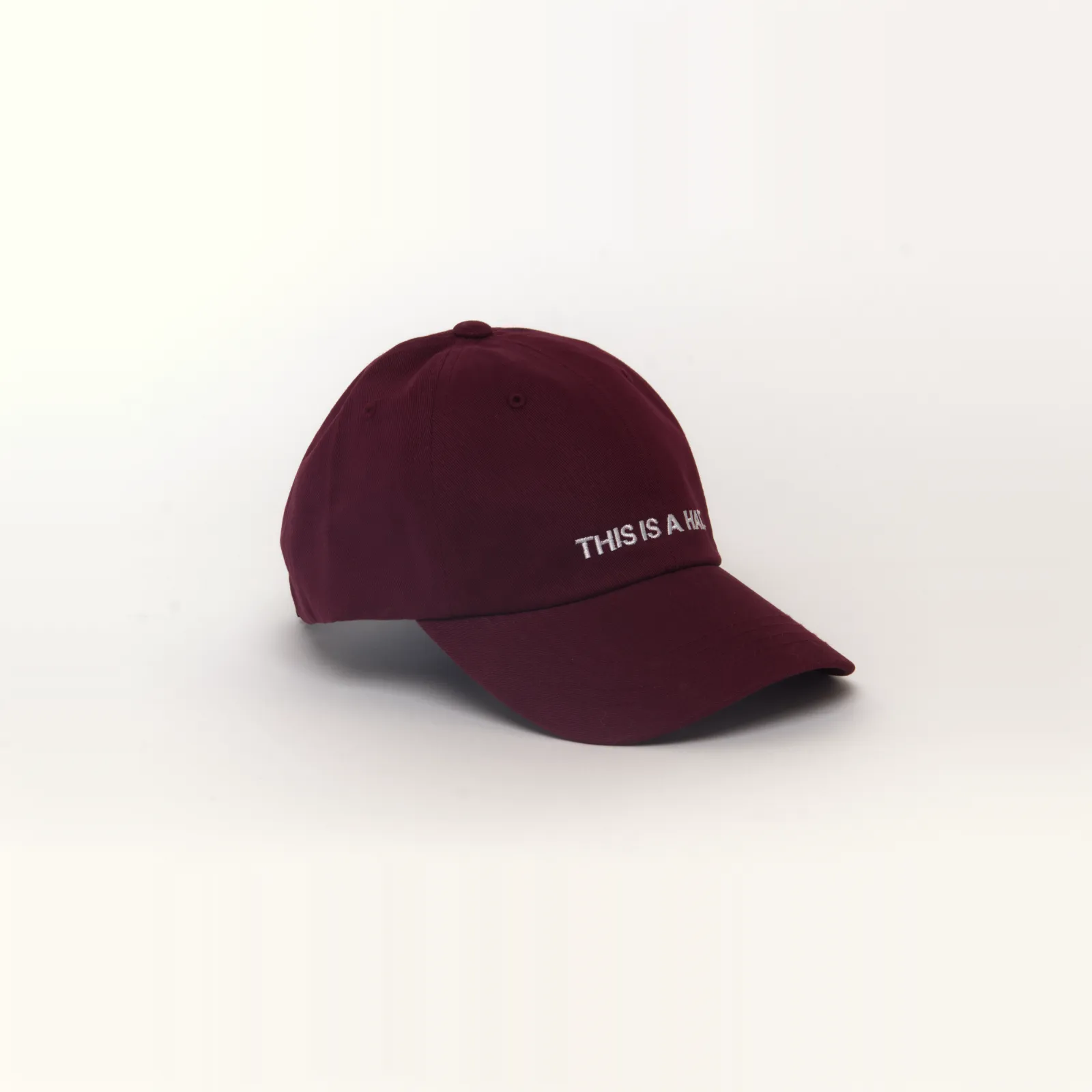 Maroon hat that says THIS IS A HAT, 3/4 view