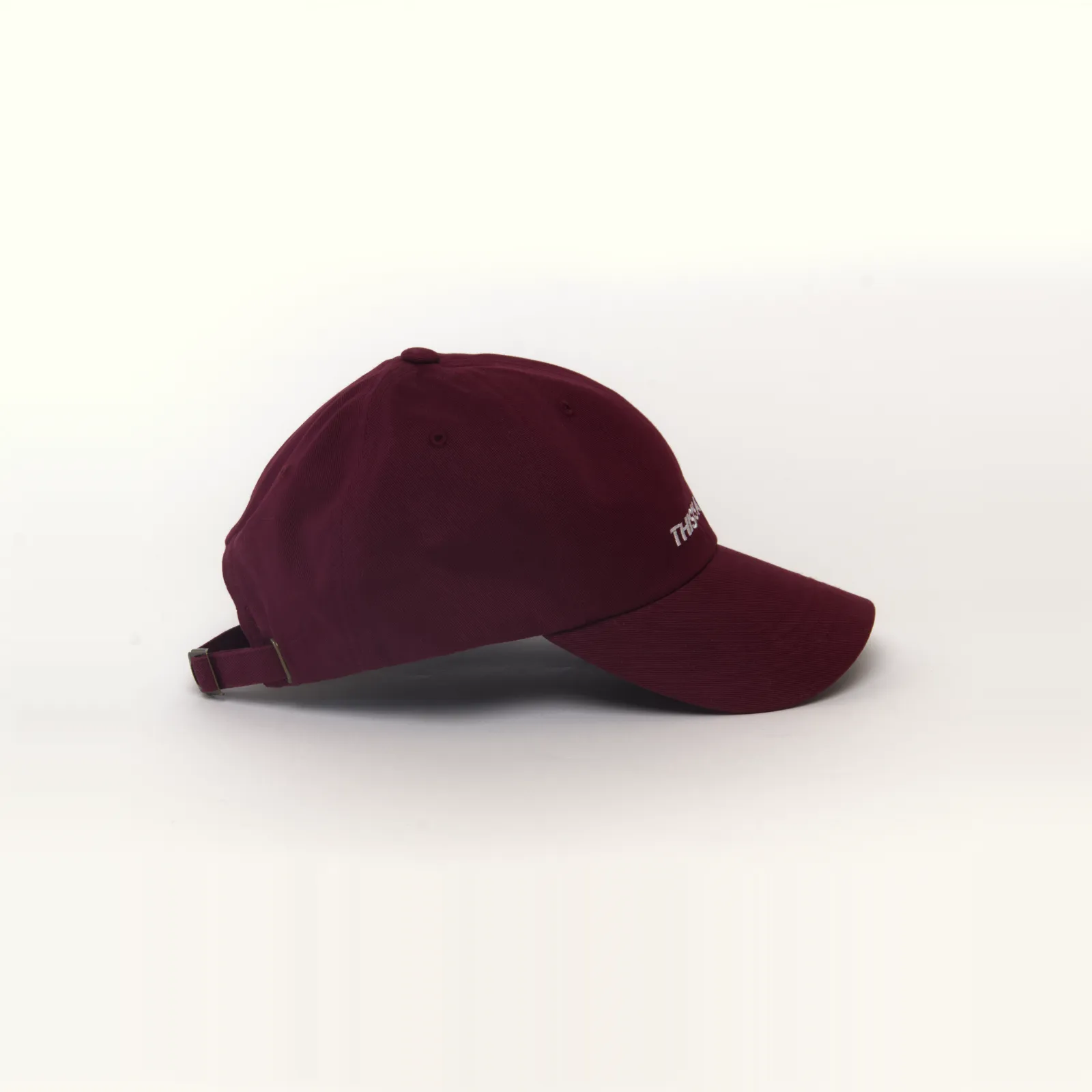 Maroon hat that says THIS IS A HAT, side view
